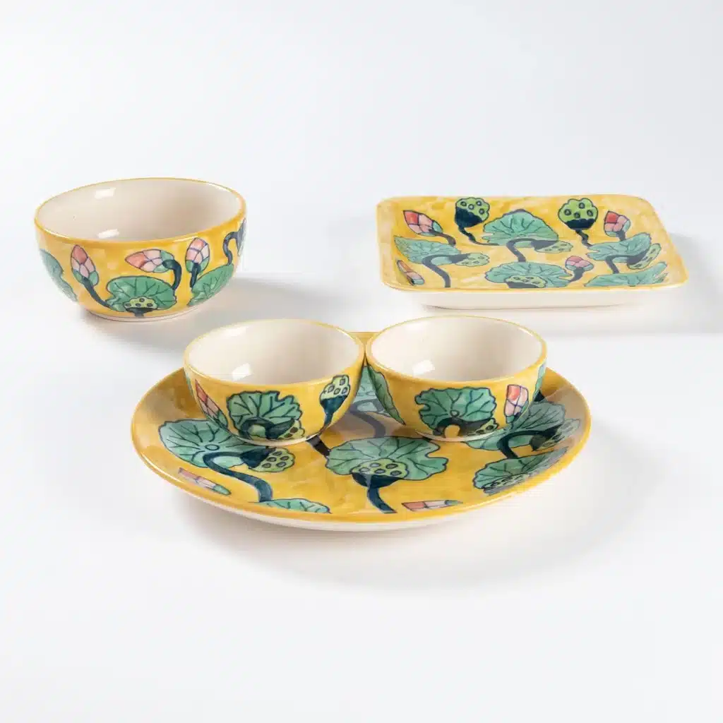 IMG_0402 Yellow ceramic dish set with floral designs, featuring bowls and plates on a white background. | Sky Rye Design Yellow ceramic dish set with floral designs, featuring bowls and plates on a white background.