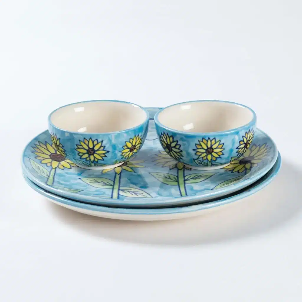 IMG_6603 Blue ceramic dish set with sunflower design, including two bowls and a plate, on a white background. | Sky Rye Design Blue ceramic dish set with sunflower design, including two bowls and a plate, on a white background.