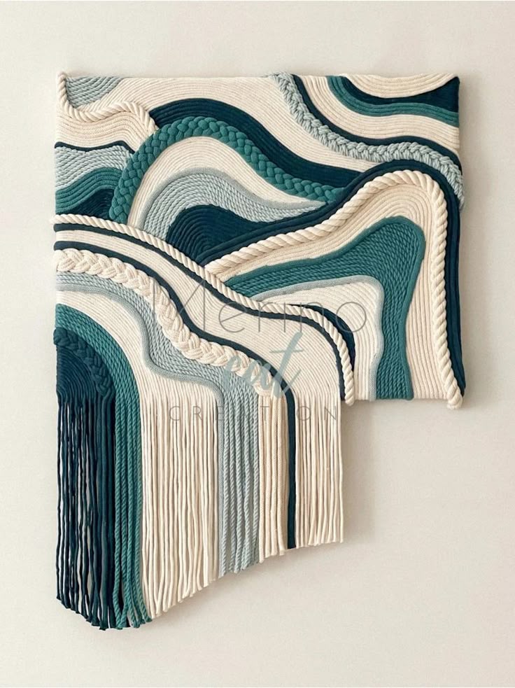 Indigo Tide Macrame Wall Hanging_ Handmade Cotton Fiber Art - Etsy Abstract macramé wall art in teal, navy, and cream with flowing braided patterns and hanging fringes. | Sky Rye Design Abstract macramé wall art in teal, navy, and cream with flowing braided patterns and hanging fringes.
