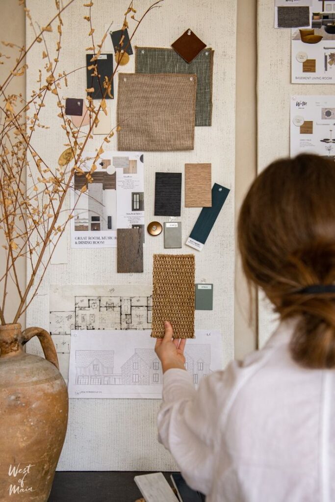 Interior Design Services - West of Main Interior designer creating mood board with fabric swatches and architectural plans on wall. | Sky Rye Design Interior designer creating mood board with fabric swatches and architectural plans on wall.