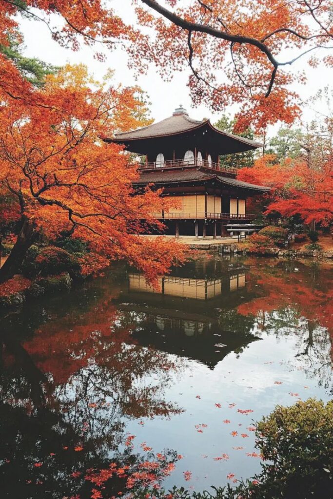Kyotos Stunning Autumn Leaves Japanese temple surrounded by vibrant autumn leaves reflected in a serene pond. | Sky Rye Design Japanese temple surrounded by vibrant autumn leaves reflected in a serene pond.
