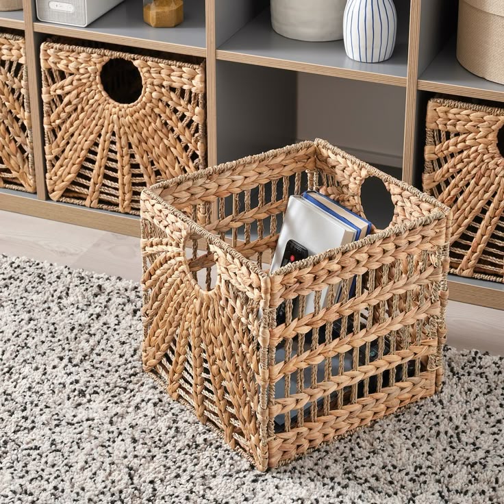 LUSTIGKURRE basket natural water hyacinth_seagrass 12 ½x13x12 ½ Woven storage basket with books on a cozy carpeted floor, enhancing modern home organization and decor. | Sky Rye Design Woven storage basket with books on a cozy carpeted floor, enhancing modern home organization and decor.