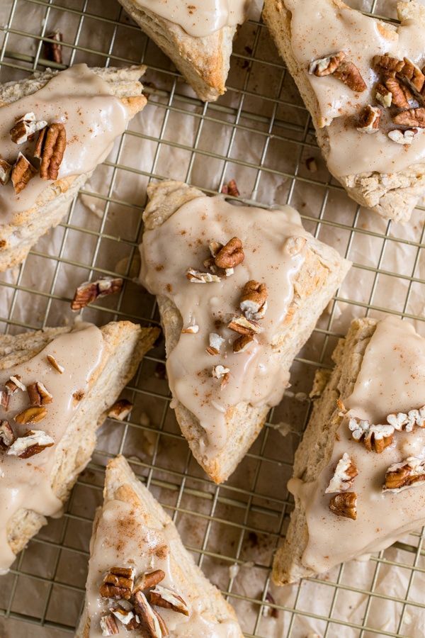 Maple Scones with Pecans Iced scones topped with chopped pecans on a cooling rack, perfect for breakfast or dessert. | Sky Rye Design Iced scones topped with chopped pecans on a cooling rack, perfect for breakfast or dessert.