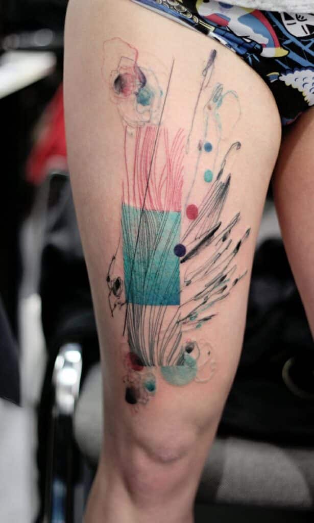 Marta Lipinski Abstract tattoo art on thigh with geometric shapes and colorful brush strokes. | Sky Rye Design Abstract tattoo art on thigh with geometric shapes and colorful brush strokes.