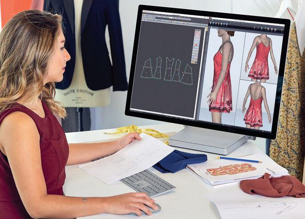 Fashion designer using CAD software to create dress patterns on a computer screen.