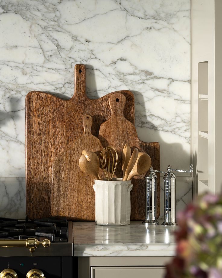 McGee Co_ _ European Chrome Salt Mill Rustic kitchen decor with wooden cutting boards and utensils on marble countertop. | Sky Rye Design Rustic kitchen decor with wooden cutting boards and utensils on marble countertop.