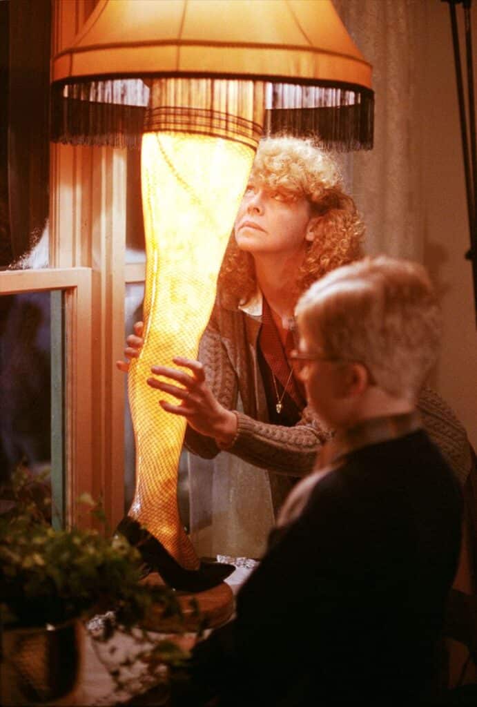 Melinda Dillon - Actress October 13 1939 January 9 2023 Woman and child admire a unique leg lamp by a window, evoking vintage style and curiosity. | Sky Rye Design Woman and child admire a unique leg lamp by a window, evoking vintage style and curiosity.