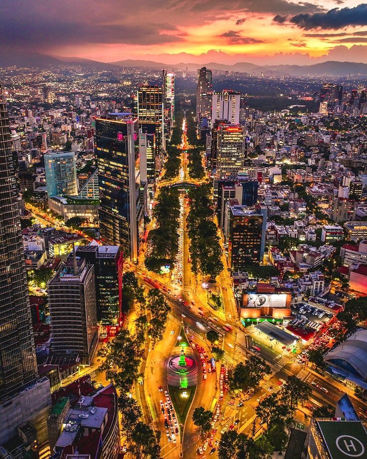 Mexico City Mexico 🇲🇽 Aerial view of a vibrant cityscape at sunset with illuminated skyscrapers and bustling streets. | Sky Rye Design Aerial view of a vibrant cityscape at sunset with illuminated skyscrapers and bustling streets.
