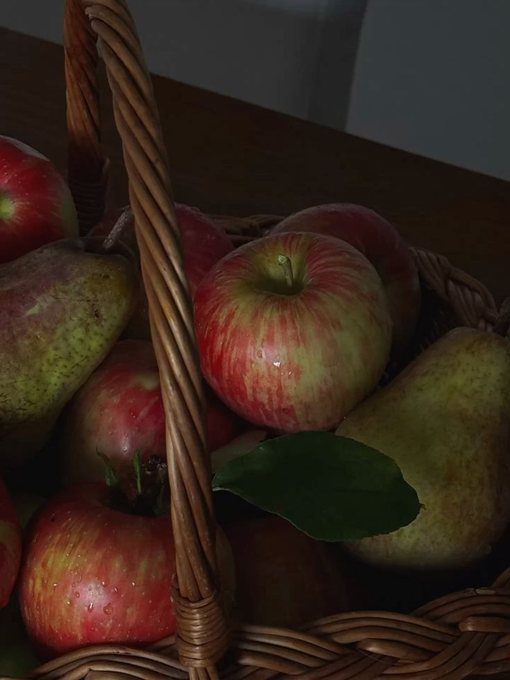Moody apple harvest Basket of fresh apples and pears with a rustic wooden handle, showcasing vibrant colors and natural textures. | Sky Rye Design Basket of fresh apples and pears with a rustic wooden handle, showcasing vibrant colors and natural textures.