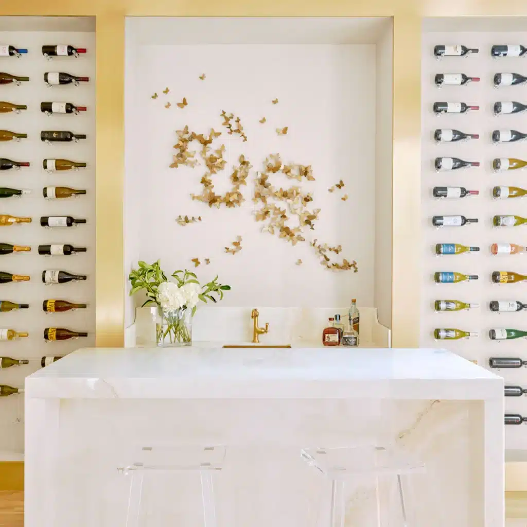 Mostupdated Luxurious home wine bar with marble counter, bottle display, decorative wall art, and a vase of fresh flowers. | Sky Rye Design Luxurious home wine bar with marble counter, bottle display, decorative wall art, and a vase of fresh flowers.