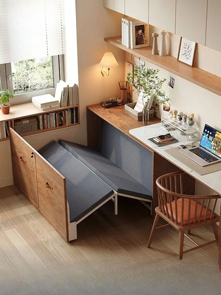 Cozy home office with wooden desk, plants, and a pull-out guest bed for small space solutions.