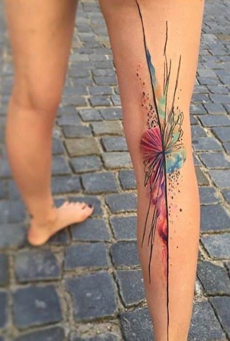 Ondrash tattoo Colorful abstract leg tattoo on cobblestone street, featuring lines and watercolor-style splashes. | Sky Rye Design Colorful abstract leg tattoo on cobblestone street, featuring lines and watercolor-style splashes.