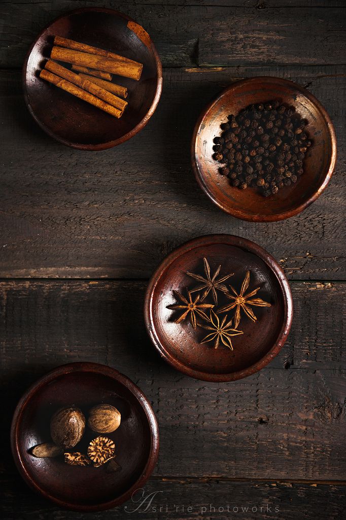 Oops Wooden bowls with cinnamon sticks, peppercorns, star anise, and nutmeg on rustic wooden table. | Sky Rye Design Wooden bowls with cinnamon sticks, peppercorns, star anise, and nutmeg on rustic wooden table.