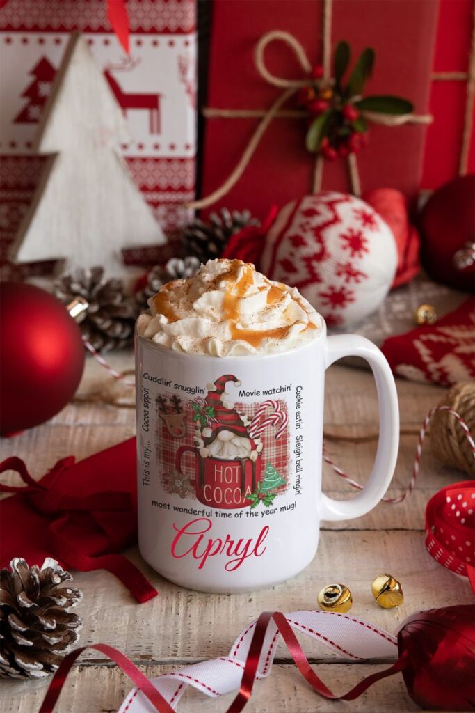 Personalized Christmas Mug Collection Festive Designs in 11oz 15oz - Pink Snow Cow _ 11oz Festive holiday mug with whipped cream and caramel, surrounded by red ornaments and wrapped gifts. | Sky Rye Design Festive holiday mug with whipped cream and caramel, surrounded by red ornaments and wrapped gifts.