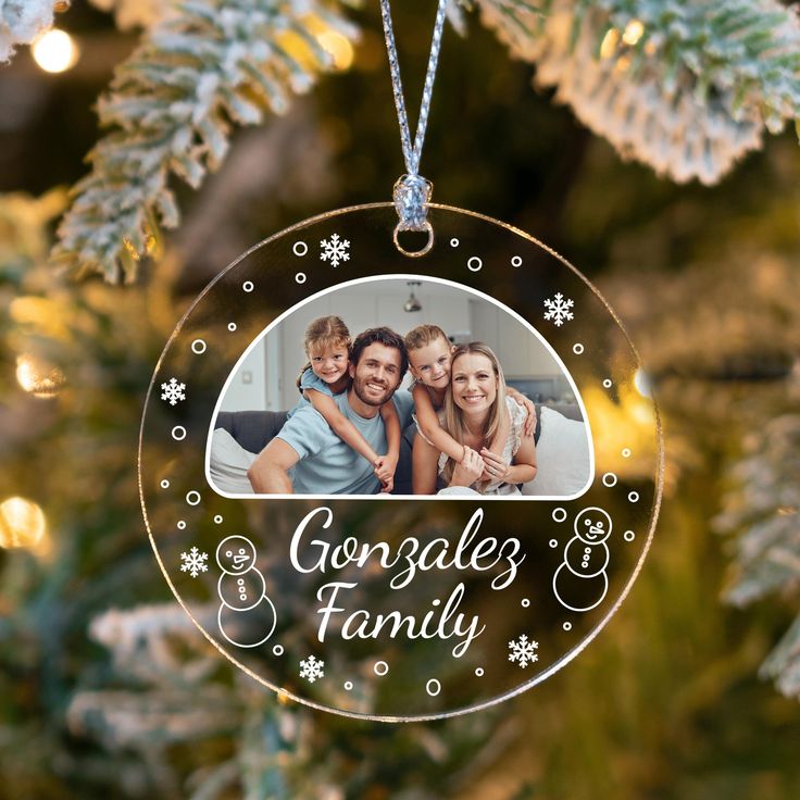 Personalized Family Photo Christmas Ornament_ Snow Globe Keepsake Family photo ornament on a Christmas tree, personalized with Gonzalez Family and snowman designs. | Sky Rye Design Family photo ornament on a Christmas tree, personalized with Gonzalez Family and snowman designs.