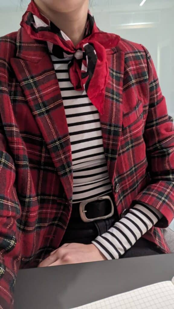 Plaid Royal Pattern Blazer Person wearing a red plaid jacket, striped shirt, and scarf. Fashionable outfit with a bold black belt accessory. | Sky Rye Design Person wearing a red plaid jacket, striped shirt, and scarf. Fashionable outfit with a bold black belt accessory.