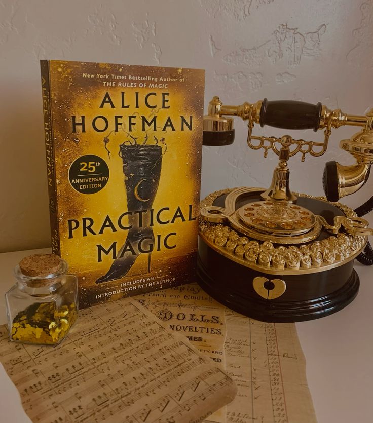 Practical magic aesthetic Practical Magic book by Alice Hoffman, vintage telephone, potion bottle, and old sheet music on a table. | Sky Rye Design Practical Magic book by Alice Hoffman, vintage telephone, potion bottle, and old sheet music on a table.