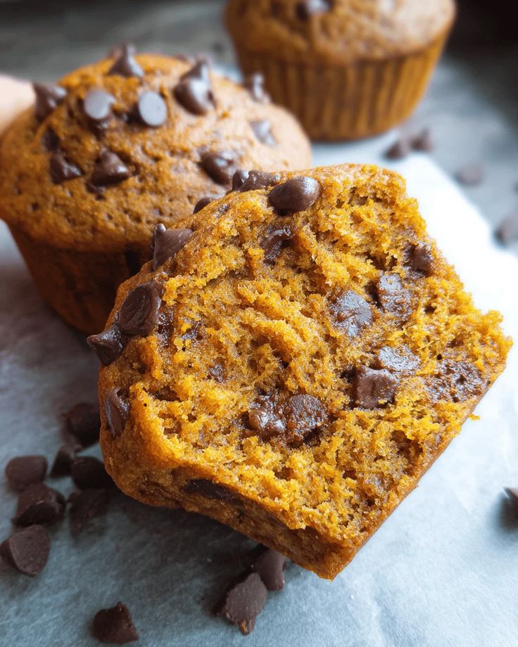 Pumpkin Chocolate Chip Muffins Pumpkin chocolate chip muffin with rich, moist texture, topped with chocolate chips, on a light background. | Sky Rye Design Pumpkin chocolate chip muffin with rich, moist texture, topped with chocolate chips, on a light background.