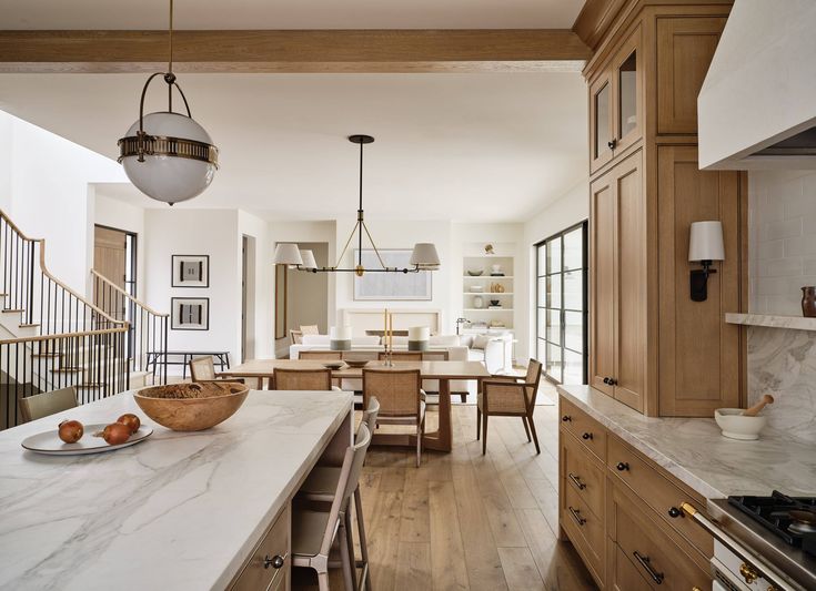 Quiet luxury interiors to inspire your home Modern open-plan kitchen and dining area with wooden cabinets, marble countertops, and natural lighting. | Sky Rye Design Modern open-plan kitchen and dining area with wooden cabinets, marble countertops, and natural lighting.