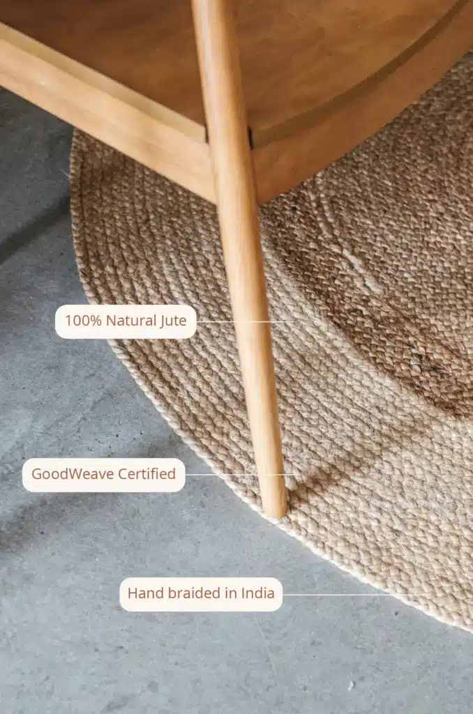 | Sky Rye Design Hand-braided natural jute rug under wooden furniture, GoodWeave certified, made in India.