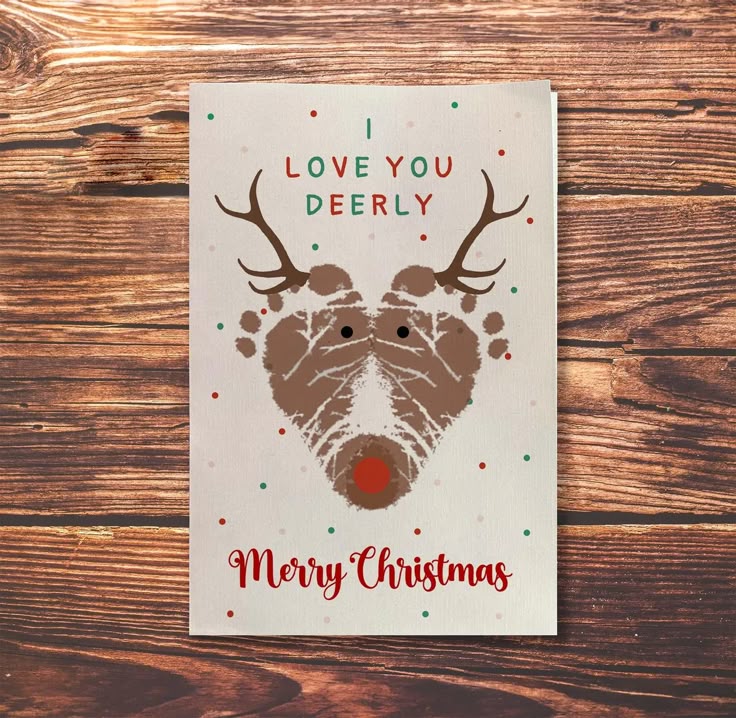 Reindeer Footprint Christmas Card_ Baby Footprint Art digital Download - Etsy Cute Christmas card with reindeer design and I love you deerly, Merry Christmas text on wooden background. | Sky Rye Design Cute Christmas card with reindeer design and I love you deerly, Merry Christmas text on wooden background.
