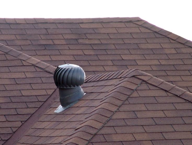 Brown shingle roof with a metal turbine vent, enhancing attic ventilation and energy efficiency.