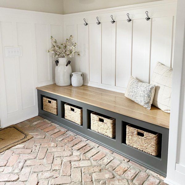 Savannah Handwoven Seagrass Utility Baskets Entryway with bench and baskets, hooks on paneled wall, and vase with flowers, creating a cozy and organized space. | Sky Rye Design Entryway with bench and baskets, hooks on paneled wall, and vase with flowers, creating a cozy and organized space.