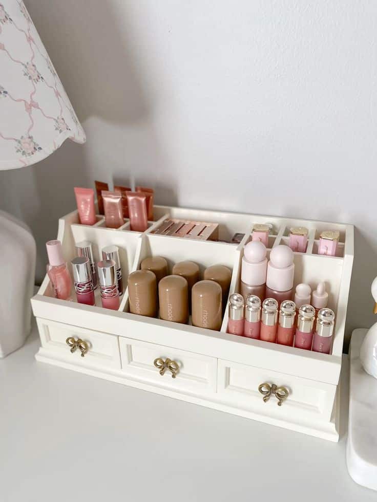 Shabby chic beauty organizer 🎀 Cosmetic organizer with lipsticks, foundations, and skincare products on a white dresser for neat storage. | Sky Rye Design Cosmetic organizer with lipsticks, foundations, and skincare products on a white dresser for neat storage.