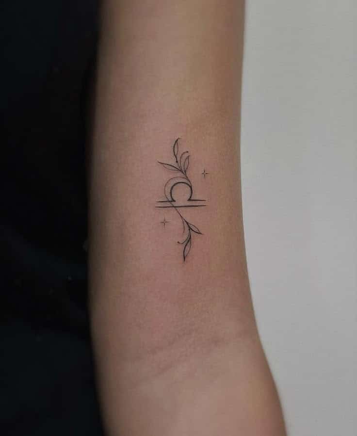 Signo libra Minimalist Libra tattoo with floral elements on an arm. | Sky Rye Design Minimalist Libra tattoo with floral elements on an arm.