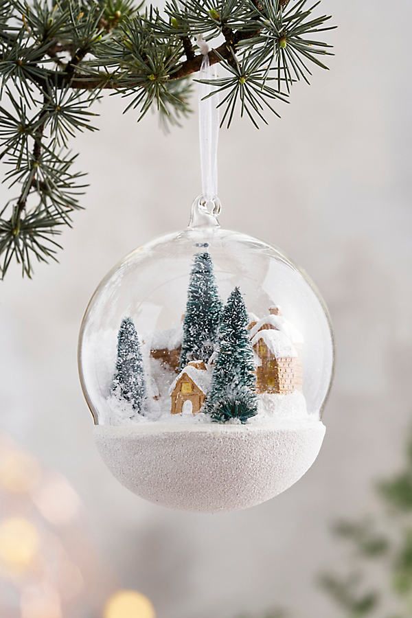 Snowy Village Glass Globe Ornament at Terrain Glass ornament with snowy village scene hanging on pine branch, perfect for festive holiday decor. | Sky Rye Design Glass ornament with snowy village scene hanging on pine branch, perfect for festive holiday decor.