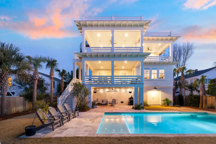 The Best Airbnbs With Pools From Malibu to Montego Bay Modern beach house with pool, palm trees, and sunset sky, ideal for luxury coastal living and vacation retreats. | Sky Rye Design Modern beach house with pool, palm trees, and sunset sky, ideal for luxury coastal living and vacation retreats.