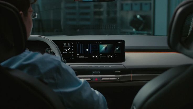 Modern car interior with high-tech digital dashboard display showing various controls and information.