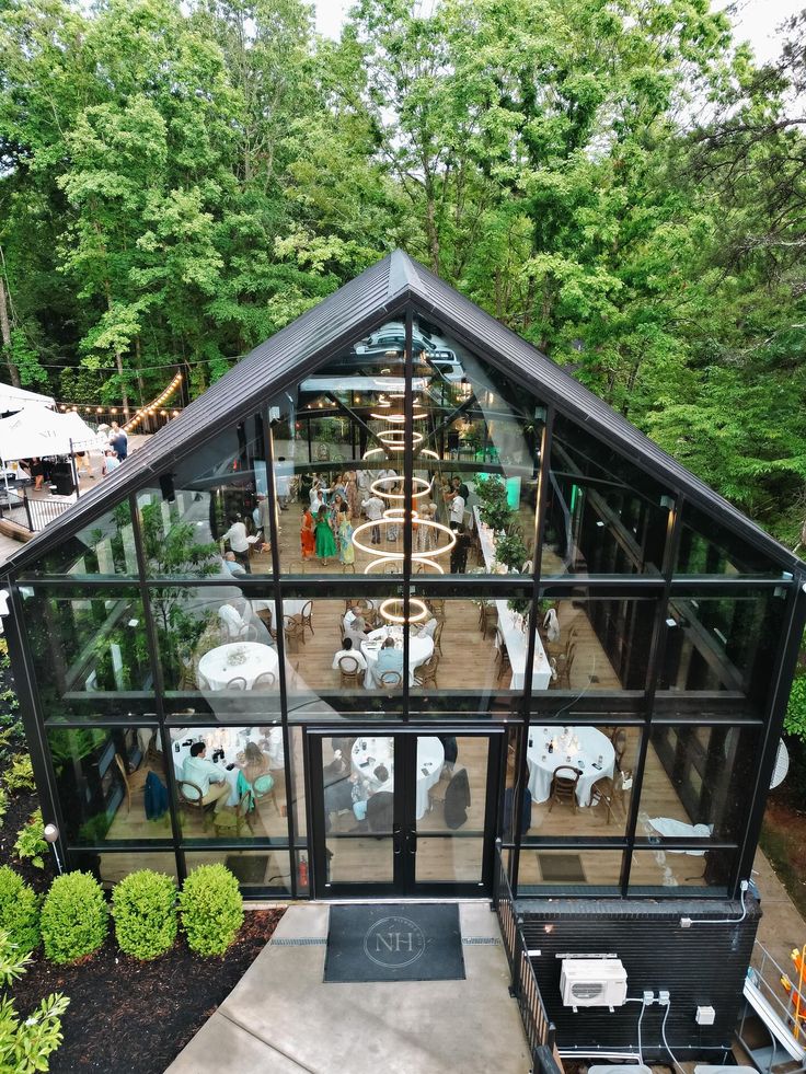 The details getting ready from one of the sweetest days for Sophie and Trae_ Convinced Ill be posting pictures from their day forever 🥰🕊️ Modern glass venue set in lush forest, hosting an elegant indoor event with guests at round tables. | Sky Rye Design Modern glass venue set in lush forest, hosting an elegant indoor event with guests at round tables.