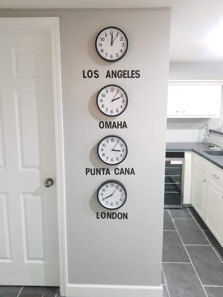 Wall clocks showing times for Los Angeles, Omaha, Punta Cana, and London in modern kitchen setting.