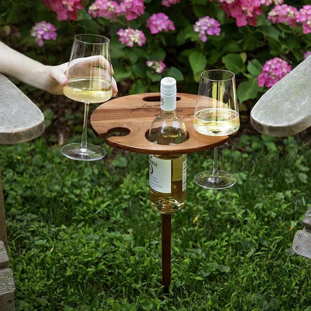 Uncommon Goods _ Portable Outdoor Wine Table _ portable picnic table _ Birthday Gifts Gifts for Her Gifts for Coworker Wine Gifts Outdoor wine table holding two glasses and a bottle, surrounded by pink flowers and greenery. Perfect for picnics. | Sky Rye Design Outdoor wine table holding two glasses and a bottle, surrounded by pink flowers and greenery. Perfect for picnics.