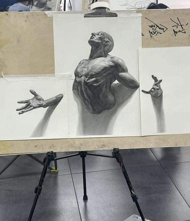 Realistic pencil sketches of a muscular figure emerging, showcasing detailed anatomy and shadowing on a studio easel.