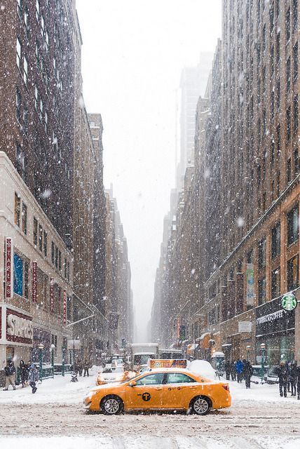 VICO Movement inspiration Yellow taxi in snowy New York City street, surrounded by tall buildings and falling snowflakes. | Sky Rye Design Yellow taxi in snowy New York City street, surrounded by tall buildings and falling snowflakes.