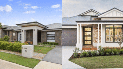 Modern suburban homes with spacious lawns and stylish facades under clear skies.