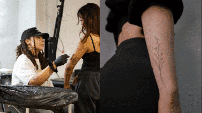 Tattoo artist working on woman's arm design; close-up of floral tattoo on a forearm.