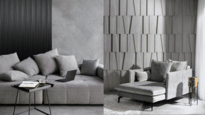 Modern gray living room with stylish sofas, laptop, books, and geometric wall panels. Cozy and contemporary interior design.