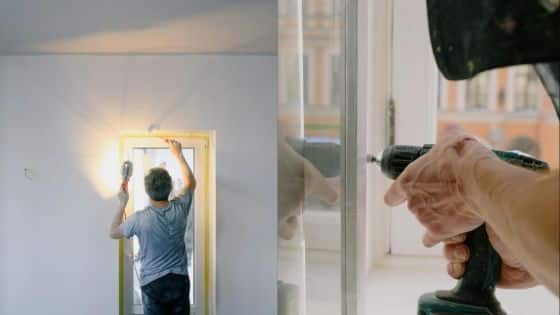 Viewing Deck Blog - 2025-10-08T005404292 Person installing a window frame with a power drill, focusing on renovation and home improvement work. | Sky Rye Design Person installing a window frame with a power drill, focusing on renovation and home improvement work.