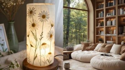 Cozy living room with large window, nature view; stylish daisy-patterned lamp adds soft, ambient lighting.