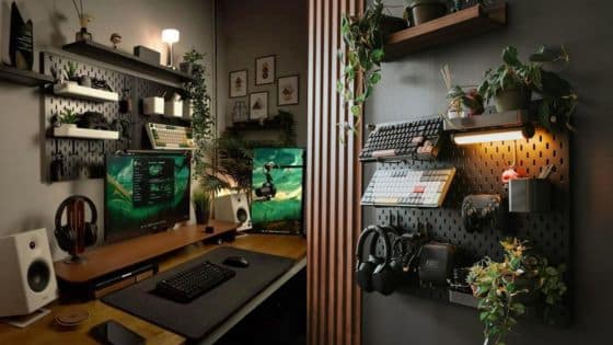 Cozy gaming setup with dual screens, mechanical keyboards, shelves, plants, and headphones for an immersive experience.