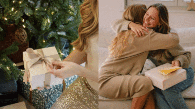 Woman wrapping gifts by Christmas tree and friends hugging on couch with presents.
