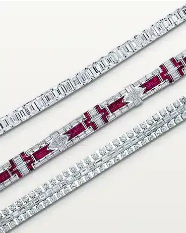 Vivid3 Three elegant bracelets: two with diamonds and one with ruby accents, showcasing intricate designs on a light background. | Sky Rye Design Three elegant bracelets: two with diamonds and one with ruby accents, showcasing intricate designs on a light background.