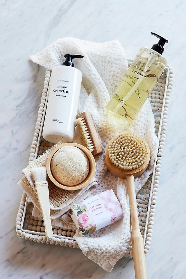 Waffle Weave Face Towel Spa essentials including grapefruit lotion, lavender soap, and brushes on a textured basket for a relaxing bath experience. | Sky Rye Design Spa essentials including grapefruit lotion, lavender soap, and brushes on a textured basket for a relaxing bath experience.
