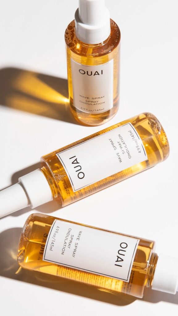 OUAI Wave Spray bottles on white background, showcasing hair styling product for beach waves.