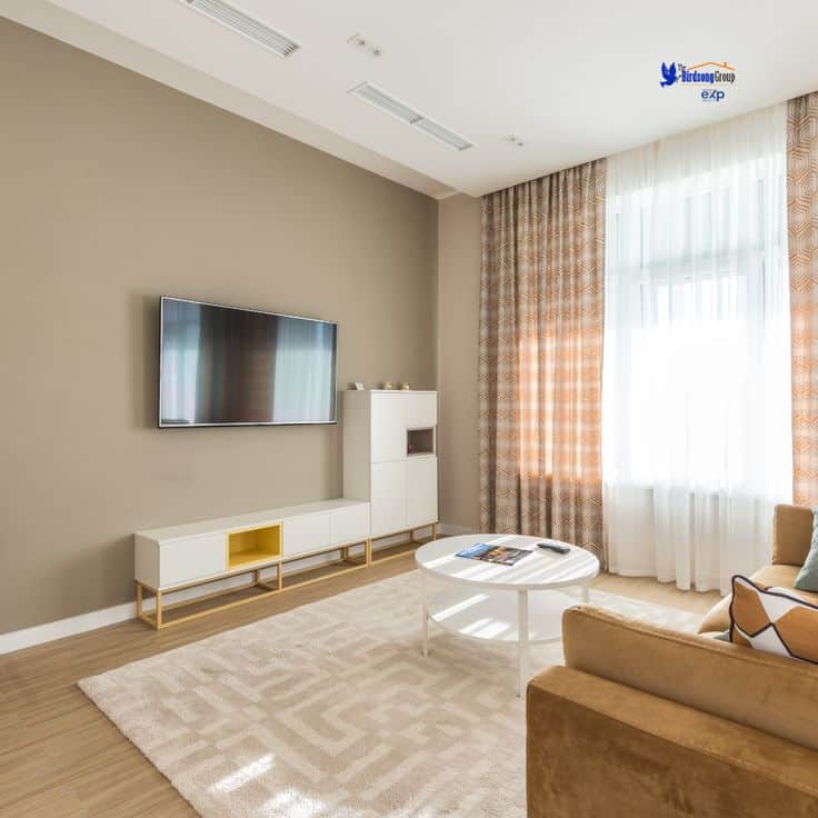 Wednesday Home Design Inspiration_ Brighten Up with Natural Light ☀️✨ Modern living room with TV, cozy sofa, coffee table, and natural light through curtains. | Sky Rye Design Modern living room with TV, cozy sofa, coffee table, and natural light through curtains.