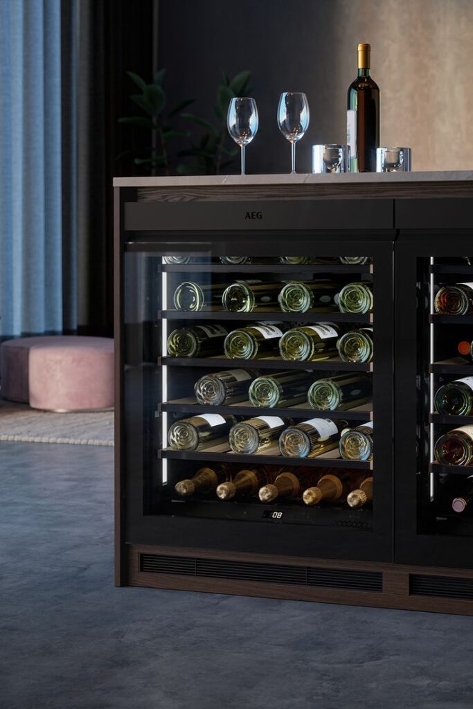 Wine Cooler - Kitchen Ideas Inspiration_ Luxury wine fridge with bottles and glasses on top for modern kitchen elegance. | Sky Rye Design Luxury wine fridge with bottles and glasses on top for modern kitchen elegance.