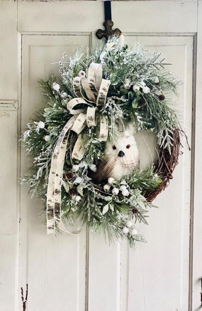 Winter Owl Wreath Grapevine Rustic Woodland Pine Wreath Neutral Winter Wall Decor Woodland Christmas Decor Birch Bow Grapevine Wreath Festive winter wreath with owl and ribbon on rustic door, featuring frosted greenery and pinecones. | Sky Rye Design Festive winter wreath with owl and ribbon on rustic door, featuring frosted greenery and pinecones.